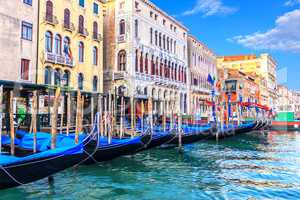 Gondolas moored near old palaces of Venice in the Grand Canal