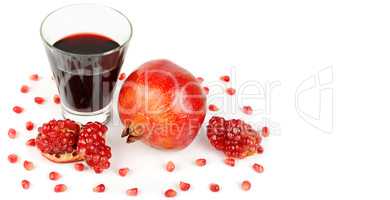 Pomegranate juice in a glass and ripe pomegranates. Isolated on