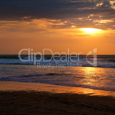 Beach of the ocean and golden sun rise.