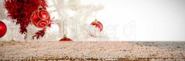 Composite image of wooden table covered with snow