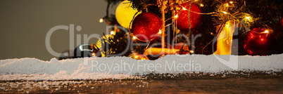 Composite image of wooden table with snow