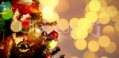 Composite image of defocused of christmas tree lights and fireplace