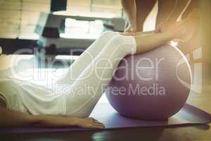 Woman exercising with ball at gym