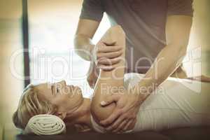 Woman receiving shoulder therapy from physiotherapist