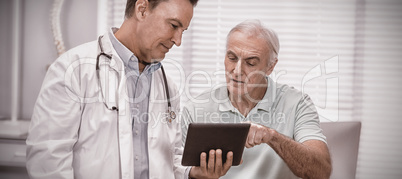 Doctor and senior patient using digital tablet Doctor and senior patient using digital tablet