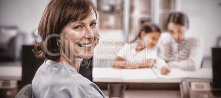 Portrait of smiling nurse sitting at desk