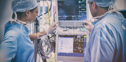 Surgeons reading computer screen