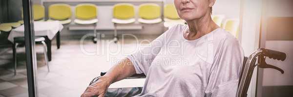 Portrait of sad senior patient sitting on a wheelchair