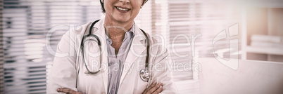 Portrait of a smiling female doctor standing with arms crossed Portrait of a smiling female doctor standing with arms crossed