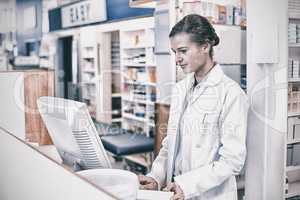 Pharmacist making prescription record through computer