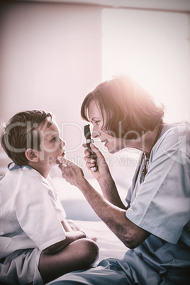 Female doctor examining patient with ophthalmic device
