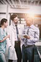 Nurse and doctor having discussion with businessman