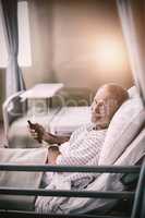 Patient watching television on bed