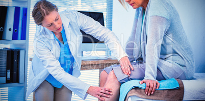 Doctor examining patient knee Doctor examining patient knee