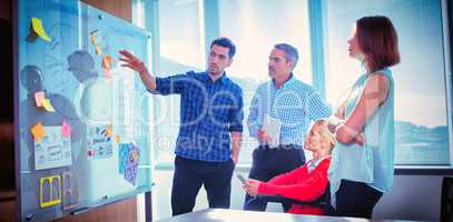 Young businessman discussing with colleagues at office