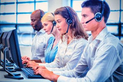 Team of colleagues working on computer with headset