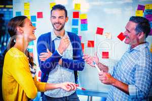 Colleagues planning in front of white board