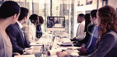 Focused business people looking at screen during video conference