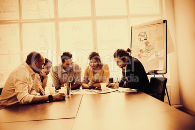 Serious photo editors discussing about photos on table