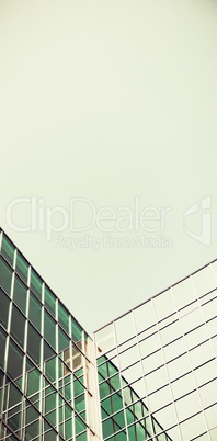 Low angle view of glass office building against blue sky