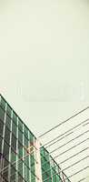 Low angle view of glass office building against blue sky