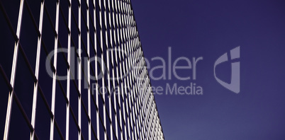 Low angle view of office building against blue sky