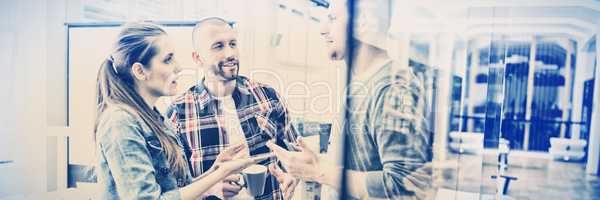 Businesswoman discussing with colleagues in office