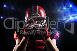 American football player standing with rugby helmet