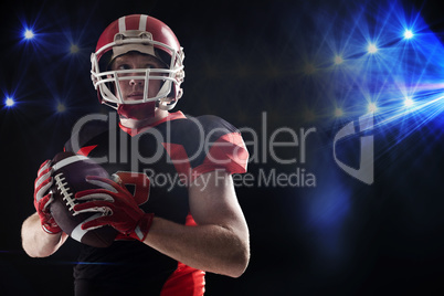 American football player in helmet holding rugby ball