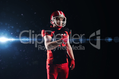 American football player in helmet holding rugby ball