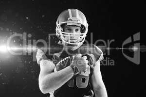 American football player in helmet holding rugby ball