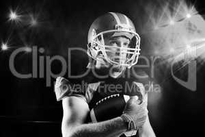 American football player in helmet holding rugby ball