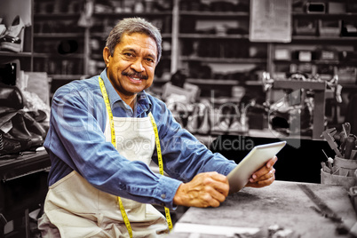 Portrait of shoemaker using digital tablet Portrait of shoemaker using digital tablet