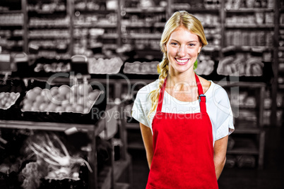 Smiling female staff standing in organic section