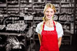 Smiling female staff standing in organic section