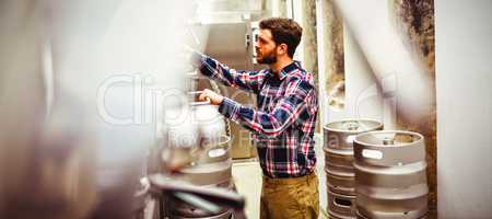 Manufacturer inspecting machineries in brewery