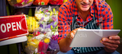 Male florist using digital tablet