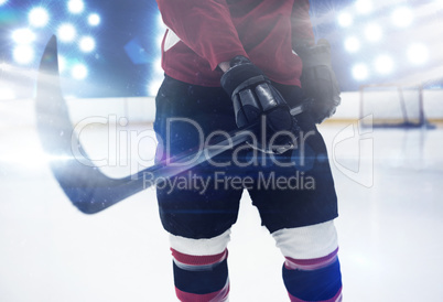 Composite image of mid section of hockey player holding stick