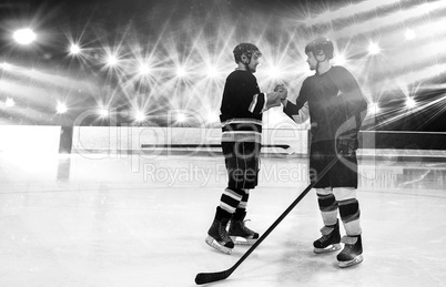 Composite image of ice hockey players shaking hands at rink