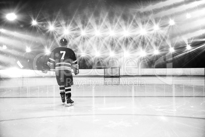Composite image of rear view of player holding ice hockey stick