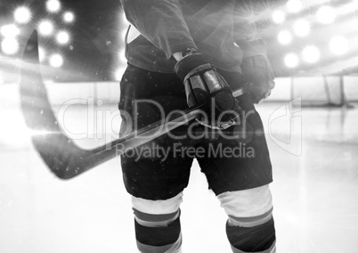 Composite image of mid section of hockey player holding stick