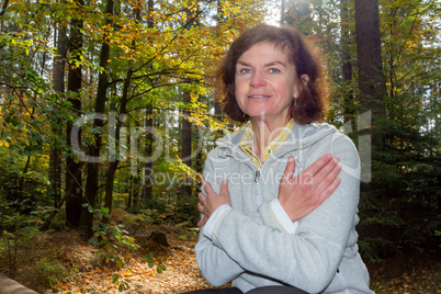 Woman is doing gymnastics in the forest