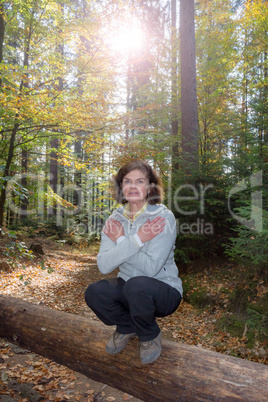 Woman is doing gymnastics in the forest