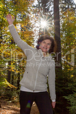 Woman is doing gymnastics in the forest