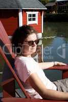 Woman is sitting at the lake