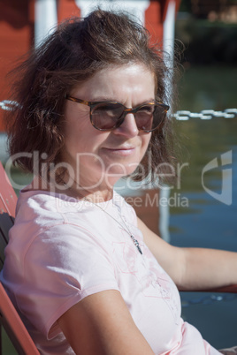 Woman is sitting at the lake