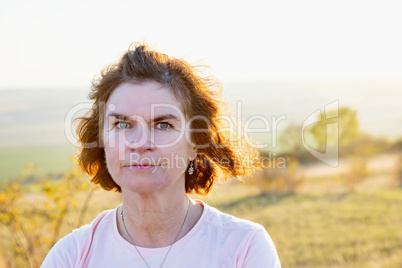 Woman in the nature at sunset
