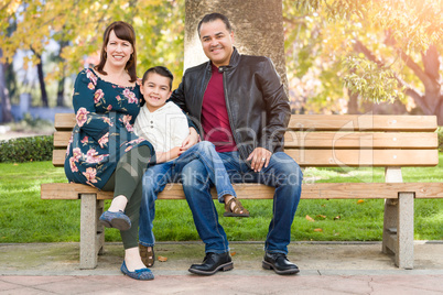 Mixed Race Young Family Portrait on a Park Bench