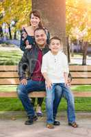 Mixed Race Young Family Portrait on a Park Bench.