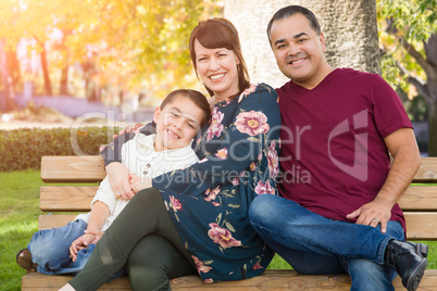 Mixed Race Young Family Portrait on a Park Bench